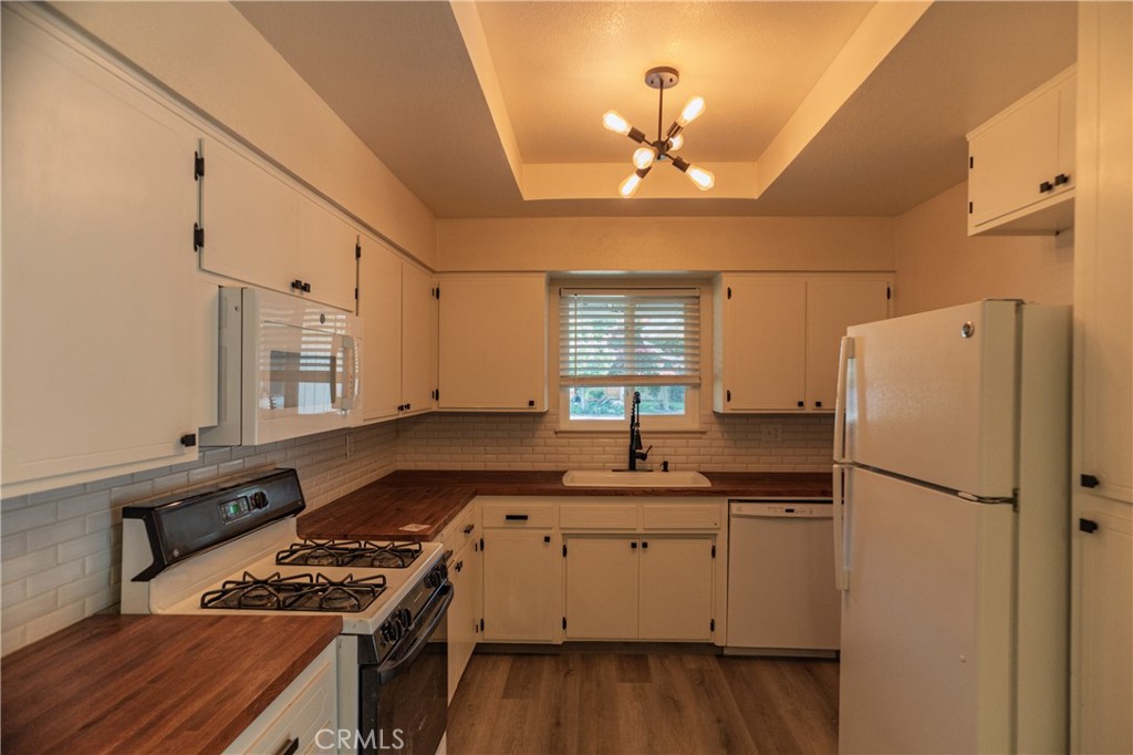 749 Junipero Court Merced, CA 95348 - Photo 11 of 57 a kitchen with a sink stove and refrigerator