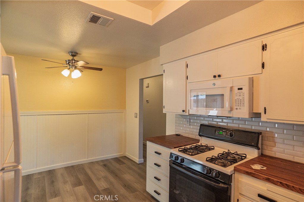 749 Junipero Court Merced, CA 95348 - Photo 12 of 57 a kitchen with a stove and a refrigerator