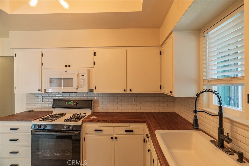 749 Junipero Court Merced, CA 95348 - Photo 13 of 57 a stove top oven sitting inside of a kitchen