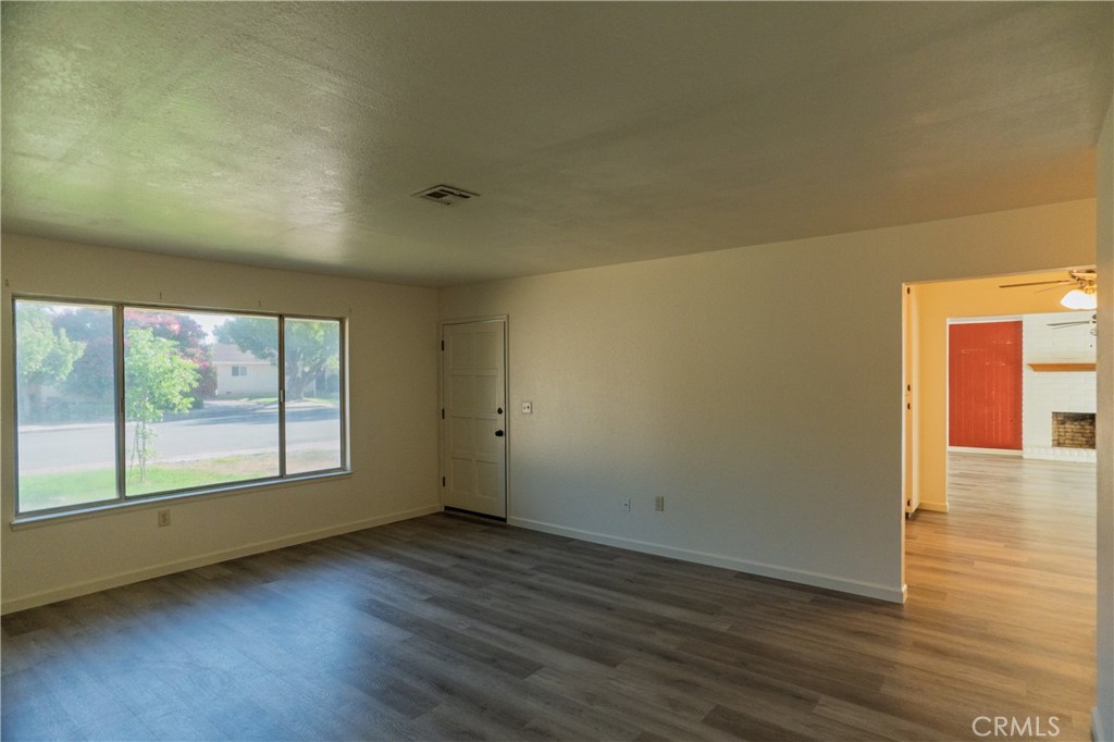 749 Junipero Court Merced, CA 95348 - Photo 16 of 57 an empty room with wooden floor and windows