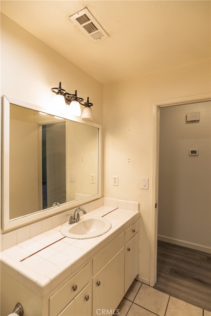 749 Junipero Court Merced, CA 95348 - Photo 18 of 57 a bathroom with a sink and a mirror