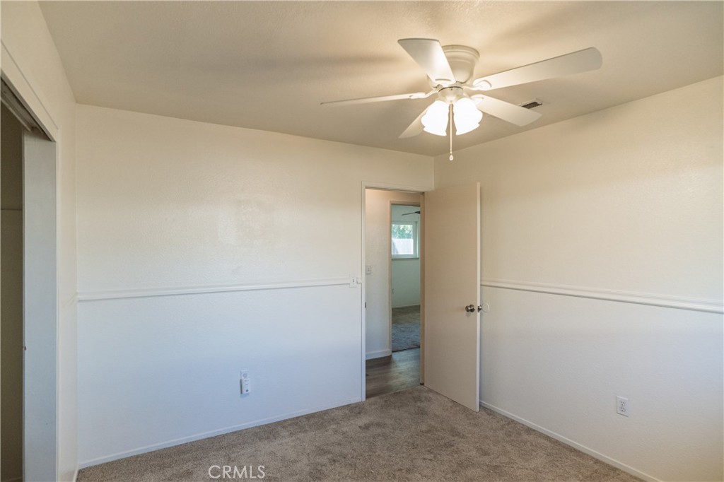 749 Junipero Court Merced, CA 95348 - Photo 20 of 57 an empty room with a ceiling fan and a window