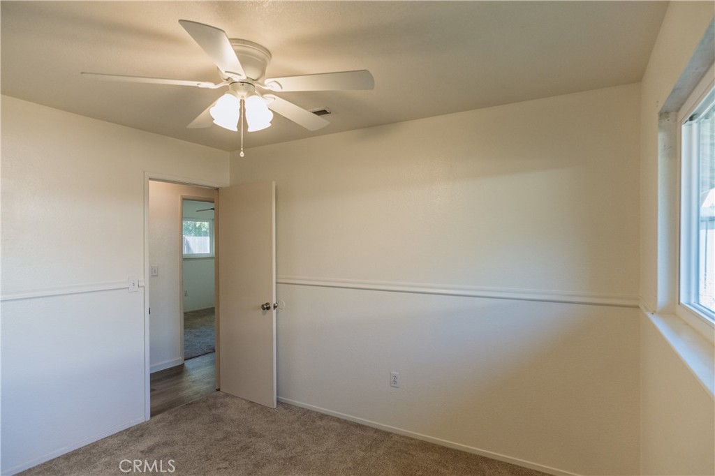 749 Junipero Court Merced, CA 95348 - Photo 21 of 57 an empty room with a window and a fan