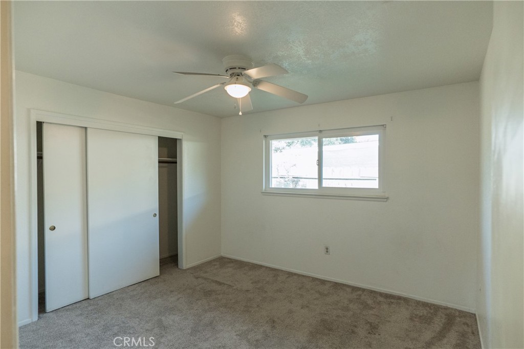 749 Junipero Court Merced, CA 95348 - Photo 27 of 57 an empty room with a window and a fan
