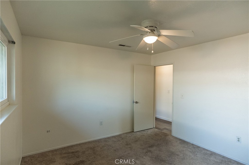 749 Junipero Court Merced, CA 95348 - Photo 28 of 57 an empty room with closet and a chandelier fan