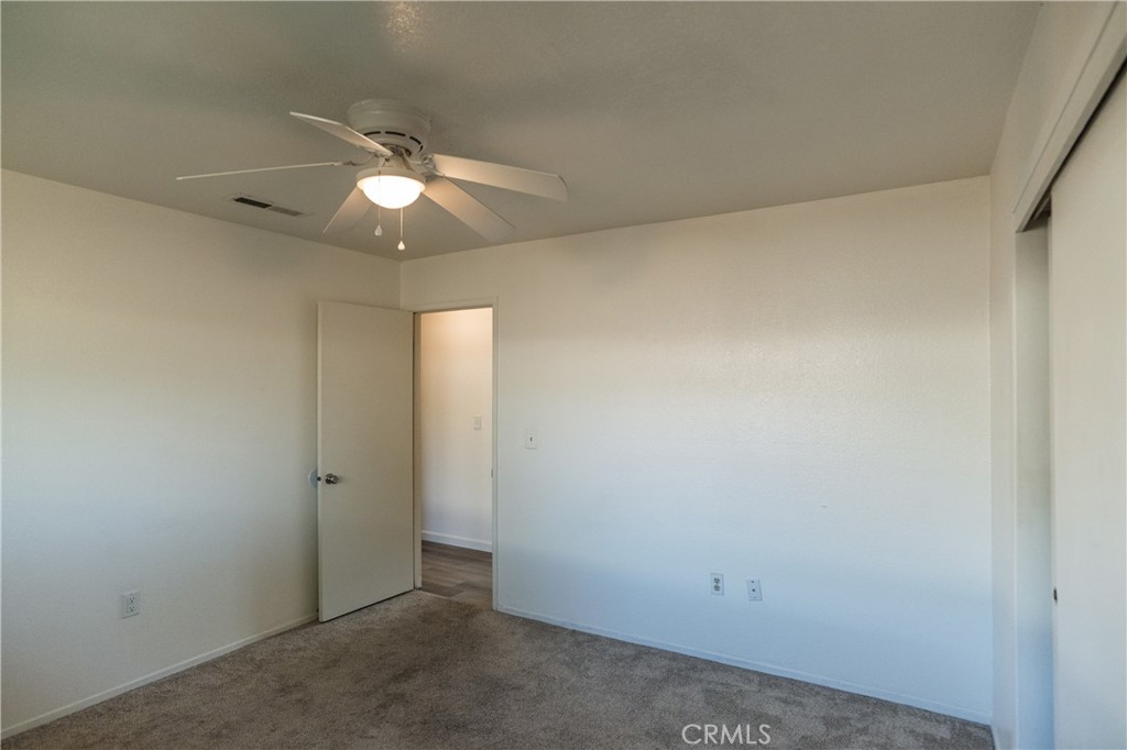 749 Junipero Court Merced, CA 95348 - Photo 29 of 57 an empty room with closet and a chandelier fan