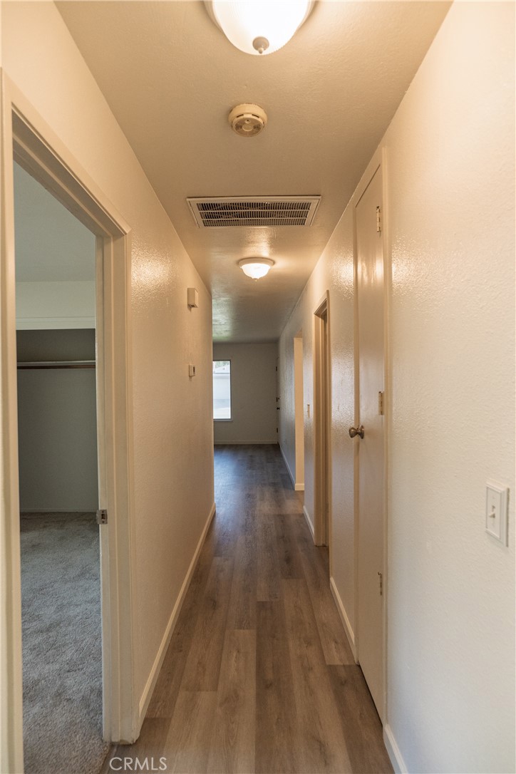 749 Junipero Court Merced, CA 95348 - Photo 30 of 57 a view of a hallway with wooden floor