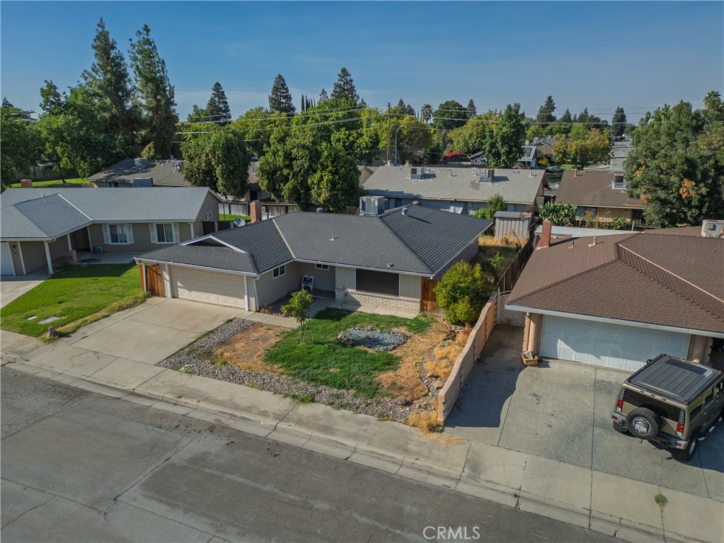 749 Junipero Court Merced, CA 95348 - Photo 35 of 57 an aerial view of a house with a garden and trees
