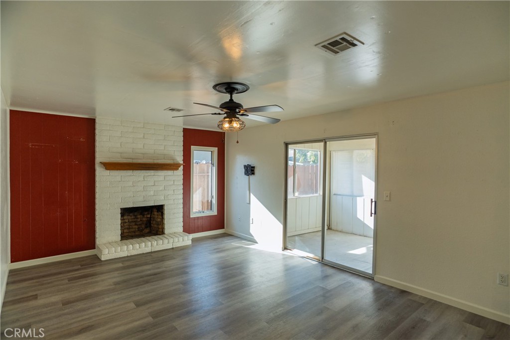 749 Junipero Court Merced, CA 95348 - Photo 4 of 57 wooden floor in an empty room with a fireplace