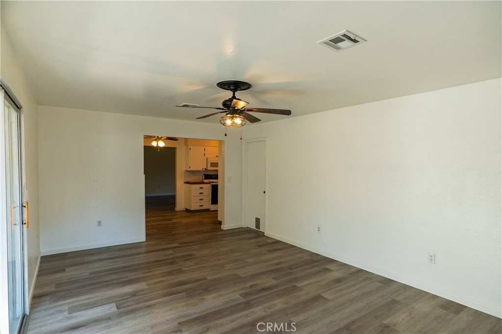 749 Junipero Court Merced, CA 95348 - Photo 7 of 57 a view of a livingroom with a chandelier fan and wooden floor