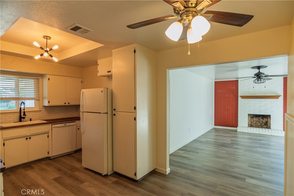 749 Junipero Court Merced, CA 95348 - Photo 10 of 57 a kitchen with a refrigerator a sink and a chandelier