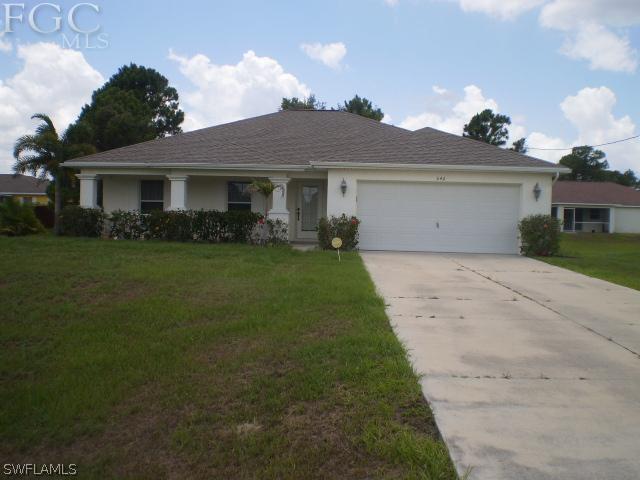 640 Homestead Road South Lehigh Acres, FL 33974 - Photo 1 of 21 a front view of a house with a garden and yard