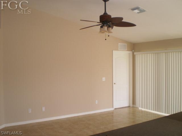 640 Homestead Road South Lehigh Acres, FL 33974 - Photo 13 of 21 an empty room with a ceiling fan and a window