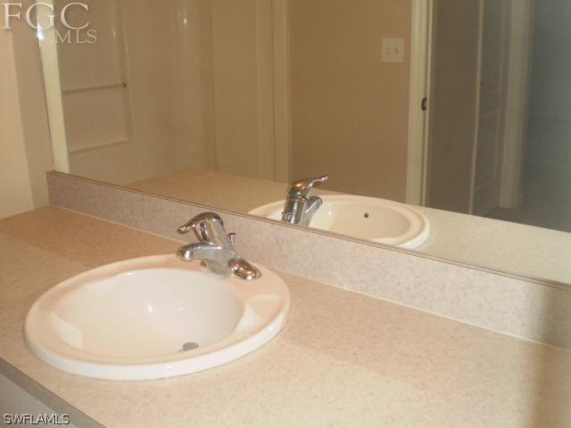 640 Homestead Road South Lehigh Acres, FL 33974 - Photo 15 of 21 a white bath tub sitting next to a white sink
