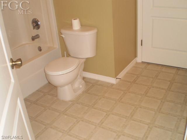 640 Homestead Road South Lehigh Acres, FL 33974 - Photo 16 of 21 a bathroom with a toilet and a shower