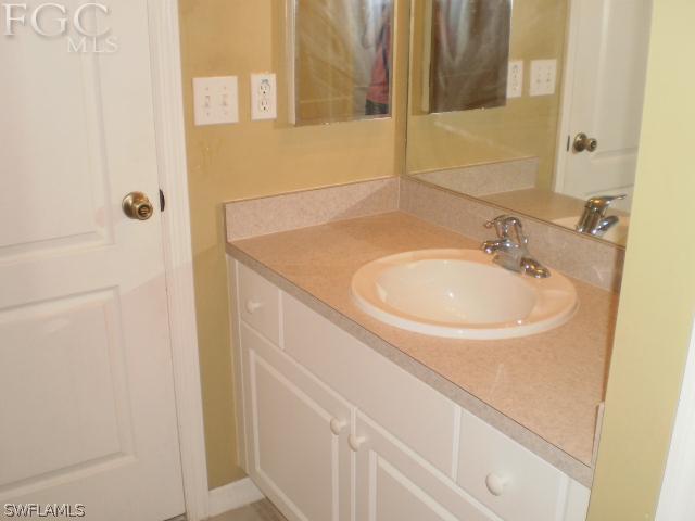 640 Homestead Road South Lehigh Acres, FL 33974 - Photo 17 of 21 a bathroom with a sink and a mirror