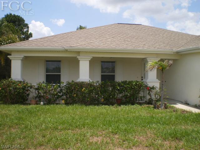 640 Homestead Road South Lehigh Acres, FL 33974 - Photo 3 of 21 a front view of a house with a garden