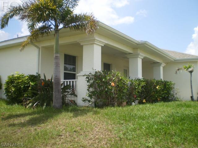 640 Homestead Road South Lehigh Acres, FL 33974 - Photo 4 of 21 a front view of a house with garden