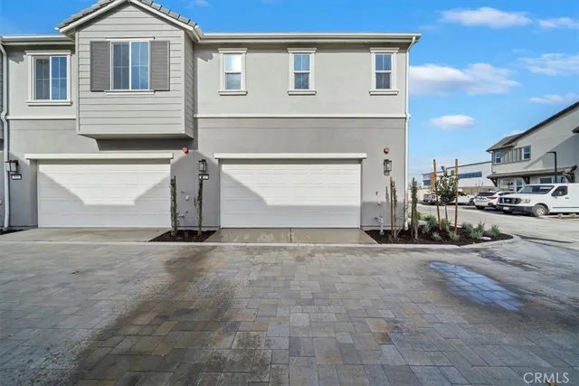 a view of a white house with a outdoor space