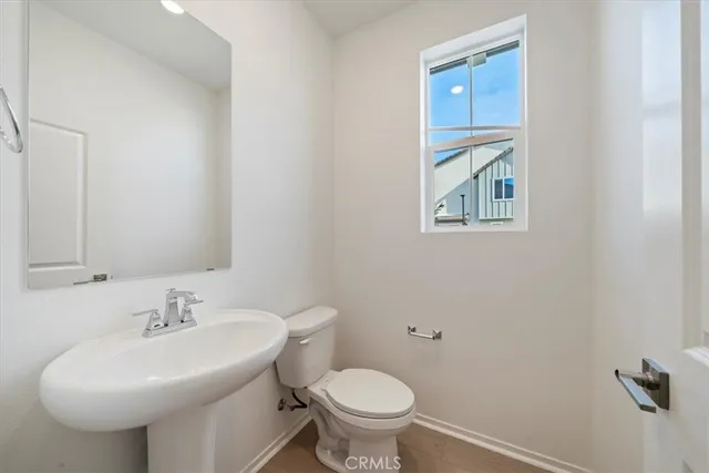 a bathroom with a sink toilet and a mirror