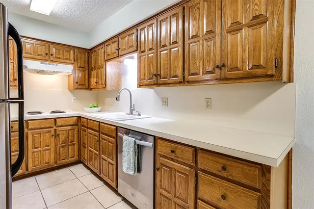 a kitchen with stainless steel appliances a sink and cabinets