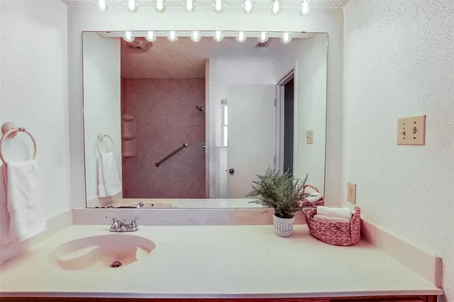 a bathroom with a sink a vanity and a mirror
