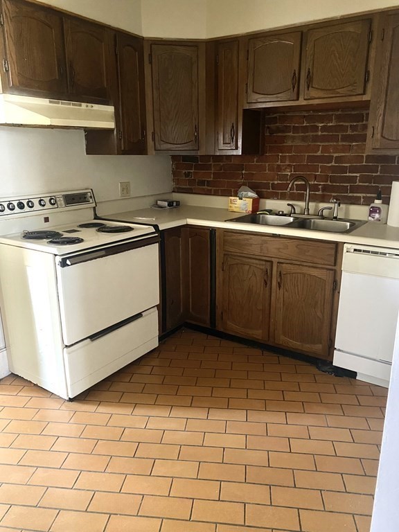 70 Temple Street, Unit 4 Springfield, MA 01105 - Photo 3 of 8 a kitchen with a sink a stove top oven and cabinets
