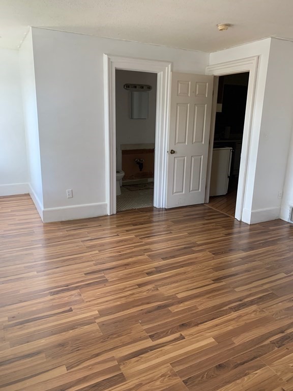 70 Temple Street, Unit 4 Springfield, MA 01105 - Photo 5 of 8 an empty room with wooden floor and closet