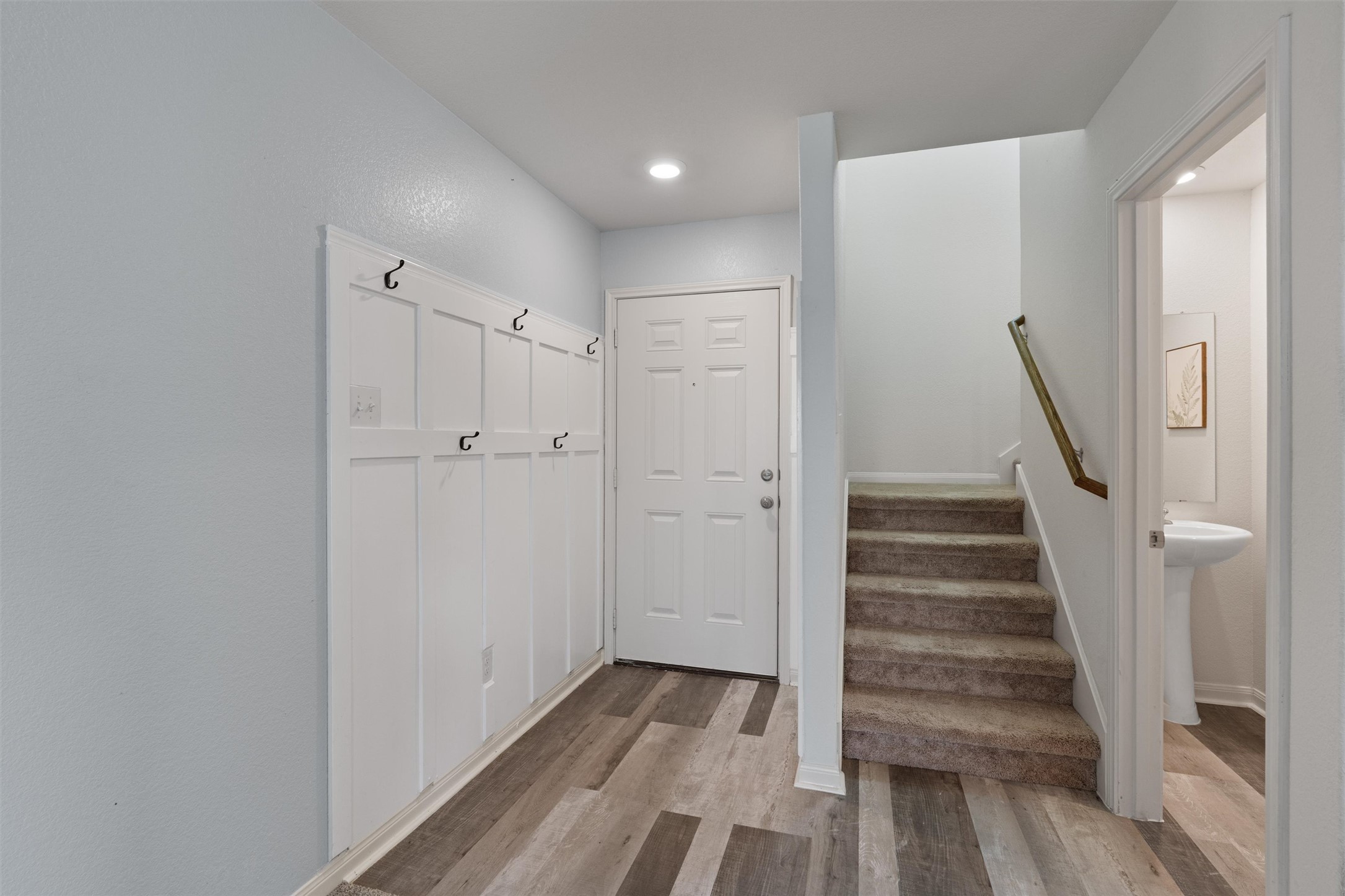 163 Niven Path, Unit 12K Jarrell, TX 76537 - Photo 4 of 31 a view of a hallway with wooden floor and entryway