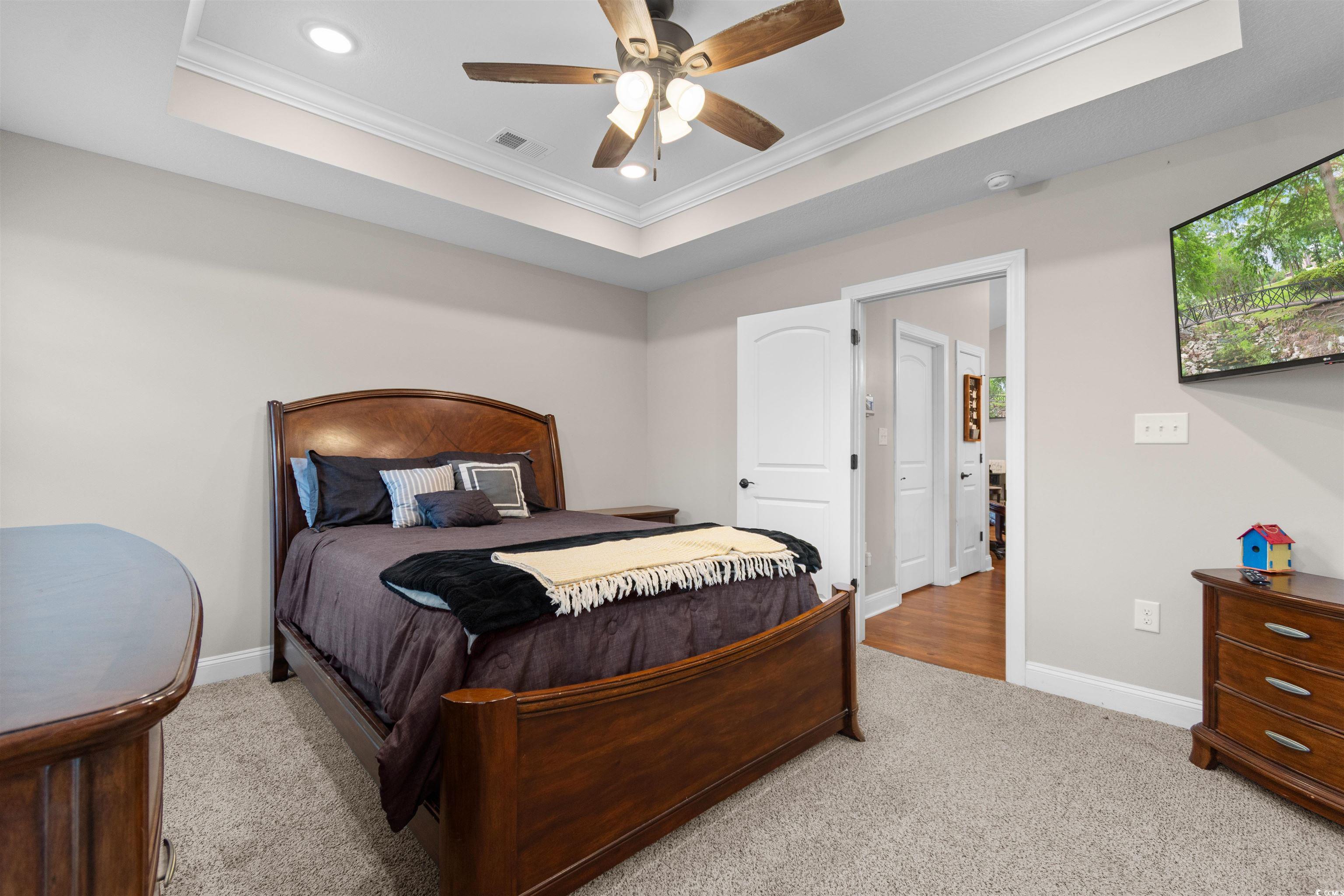 3753 Edwards Road Aynor, SC 29544 - Photo 15 of 38 Bedroom with a raised ceiling, crown molding, a ceiling fan, light carpet, and recessed lighting