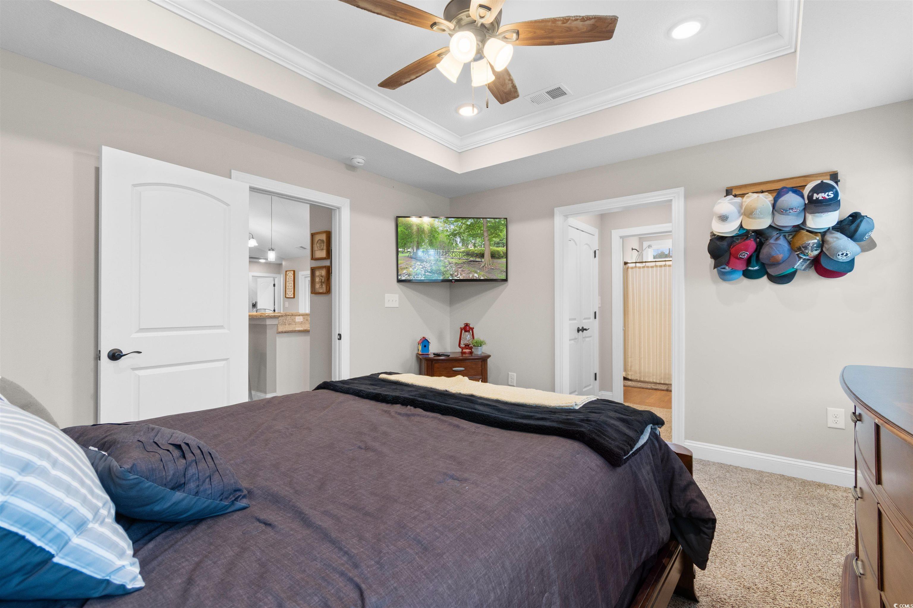 3753 Edwards Road Aynor, SC 29544 - Photo 16 of 38 Carpeted bedroom with ensuite bathroom, crown molding, a raised ceiling, recessed lighting, and a ceiling fan
