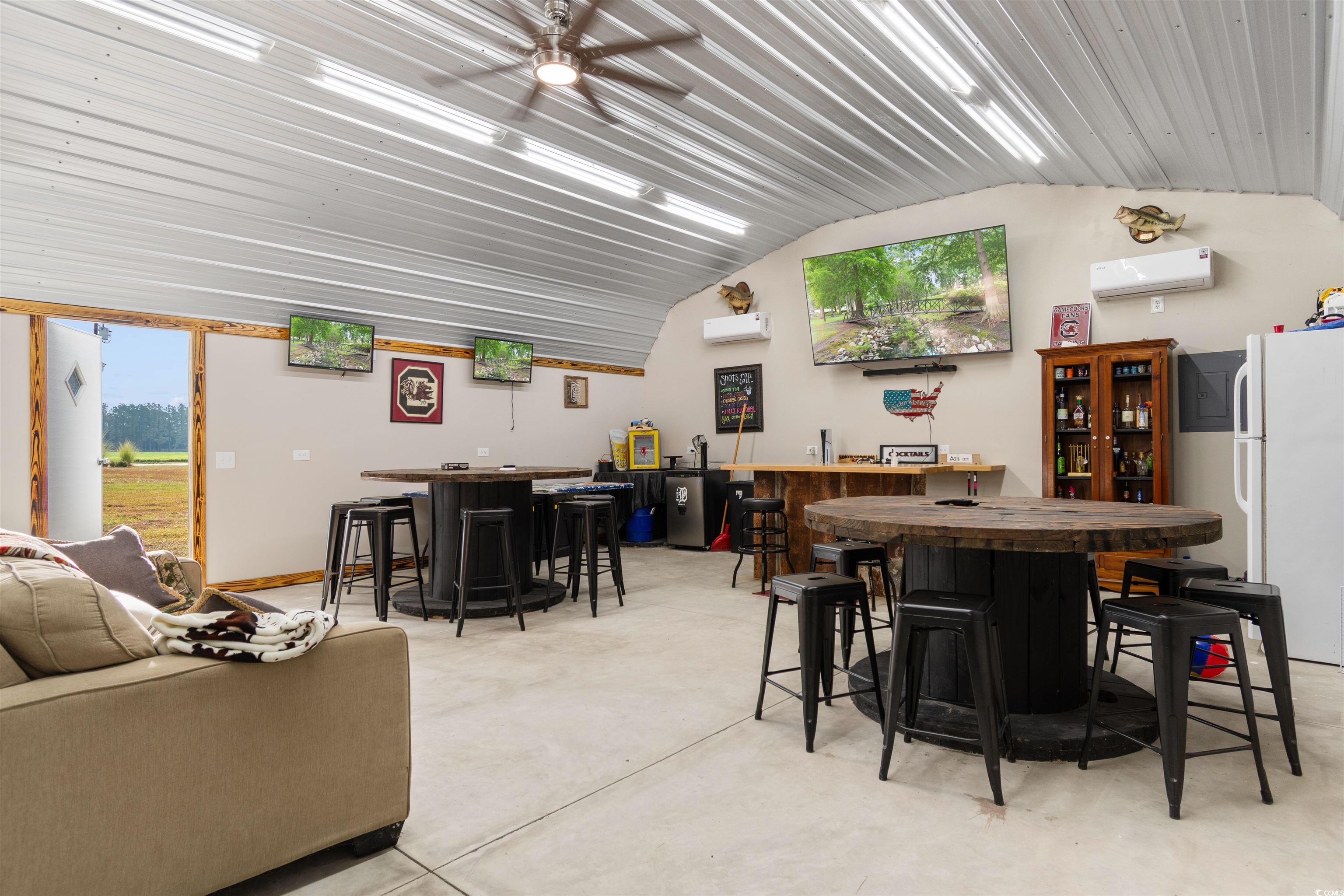 3753 Edwards Road Aynor, SC 29544 - Photo 30 of 38 Dining room featuring bar, concrete floors, an AC wall unit, and a ceiling fan