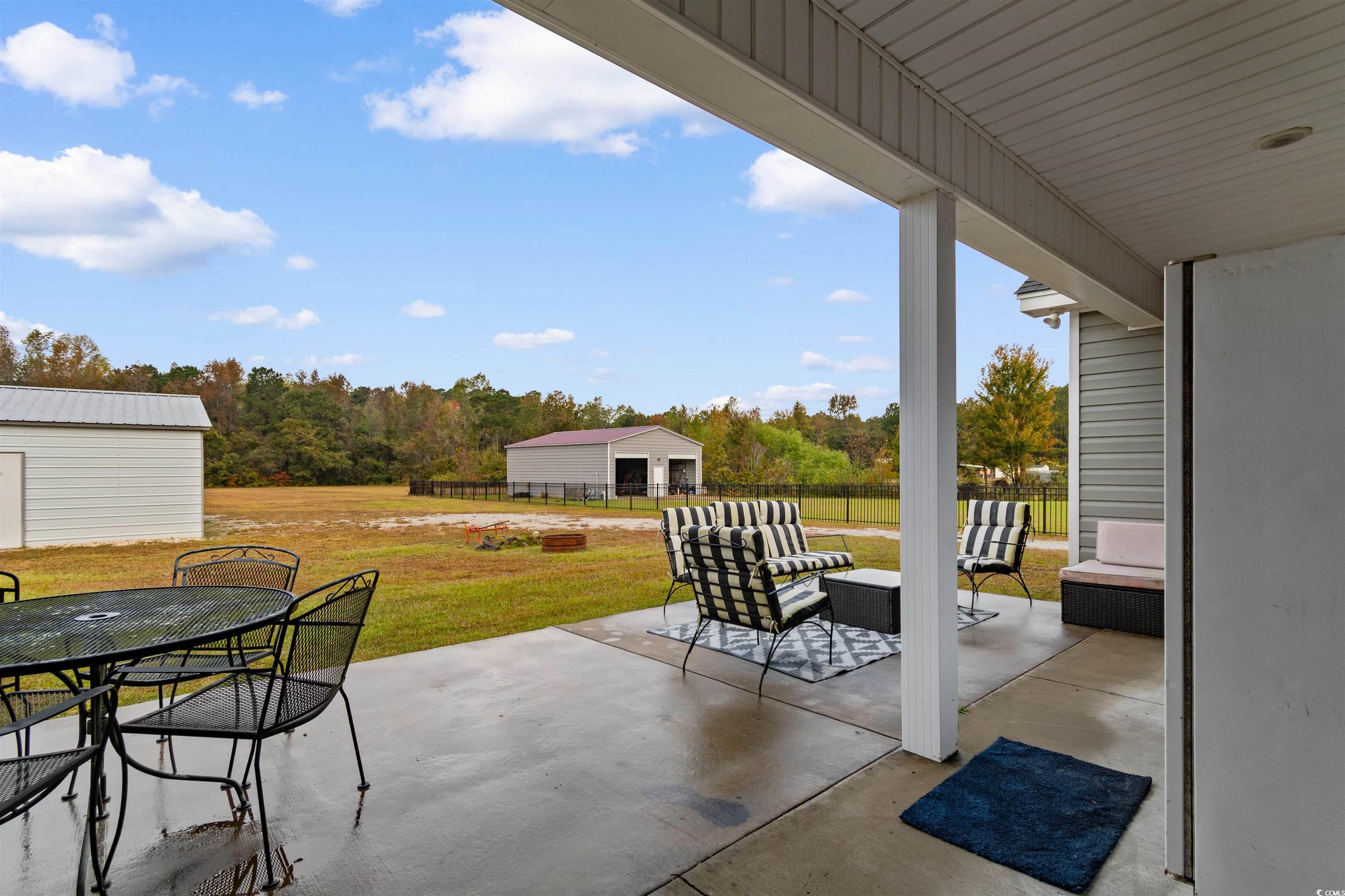 3753 Edwards Road Aynor, SC 29544 - Photo 31 of 38 View of patio with an outbuilding, outdoor dining space, and an outdoor hangout area