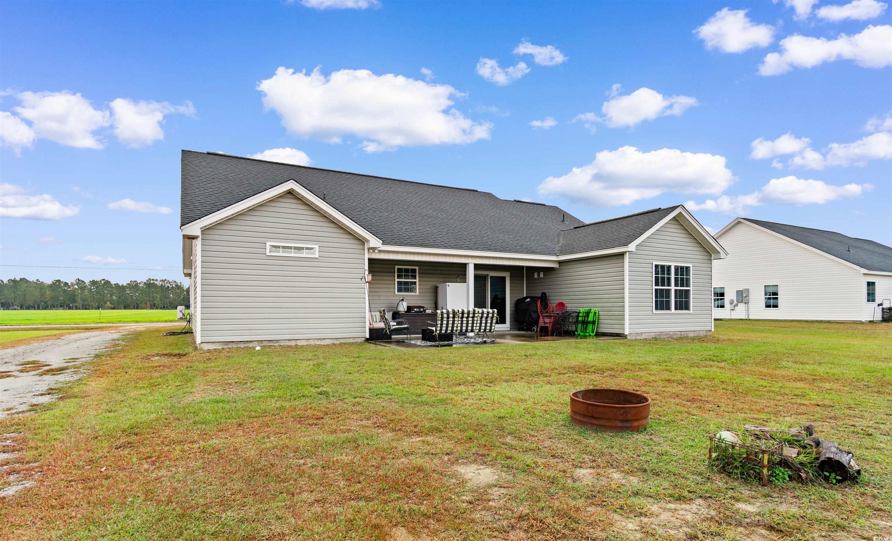 3753 Edwards Road Aynor, SC 29544 - Photo 33 of 38 Rear view of house with a yard, a shingled roof, and a patio