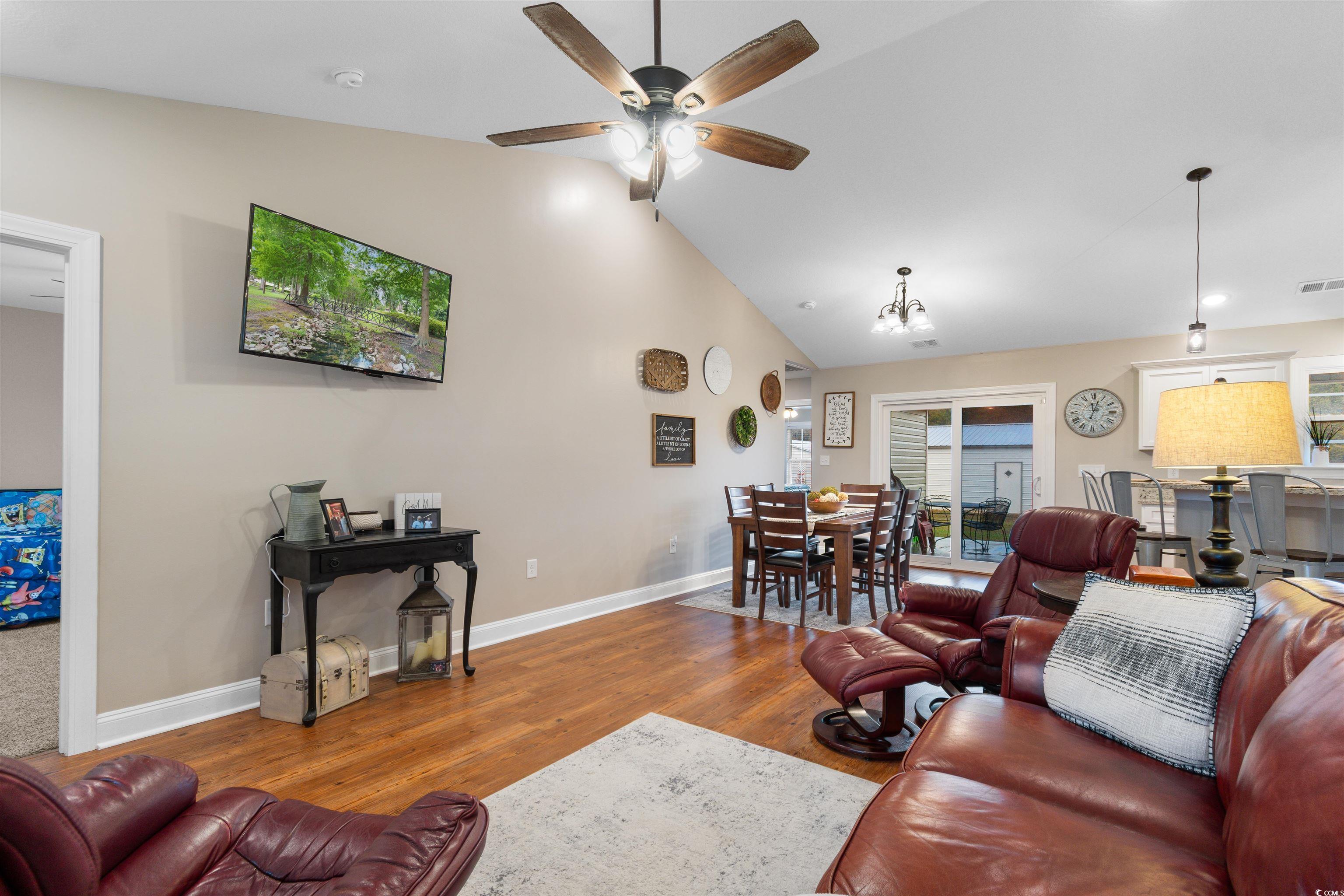 3753 Edwards Road Aynor, SC 29544 - Photo 7 of 38 Living area with vaulted ceiling, wood finished floors, and a ceiling fan