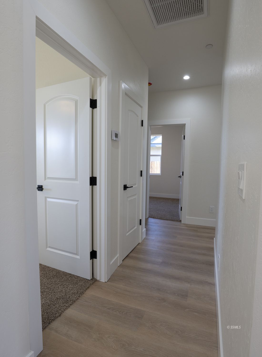 1528 Mayo Street Ridgecrest, CA 93555 - Photo 15 of 34 a view of a hallway with wooden floor