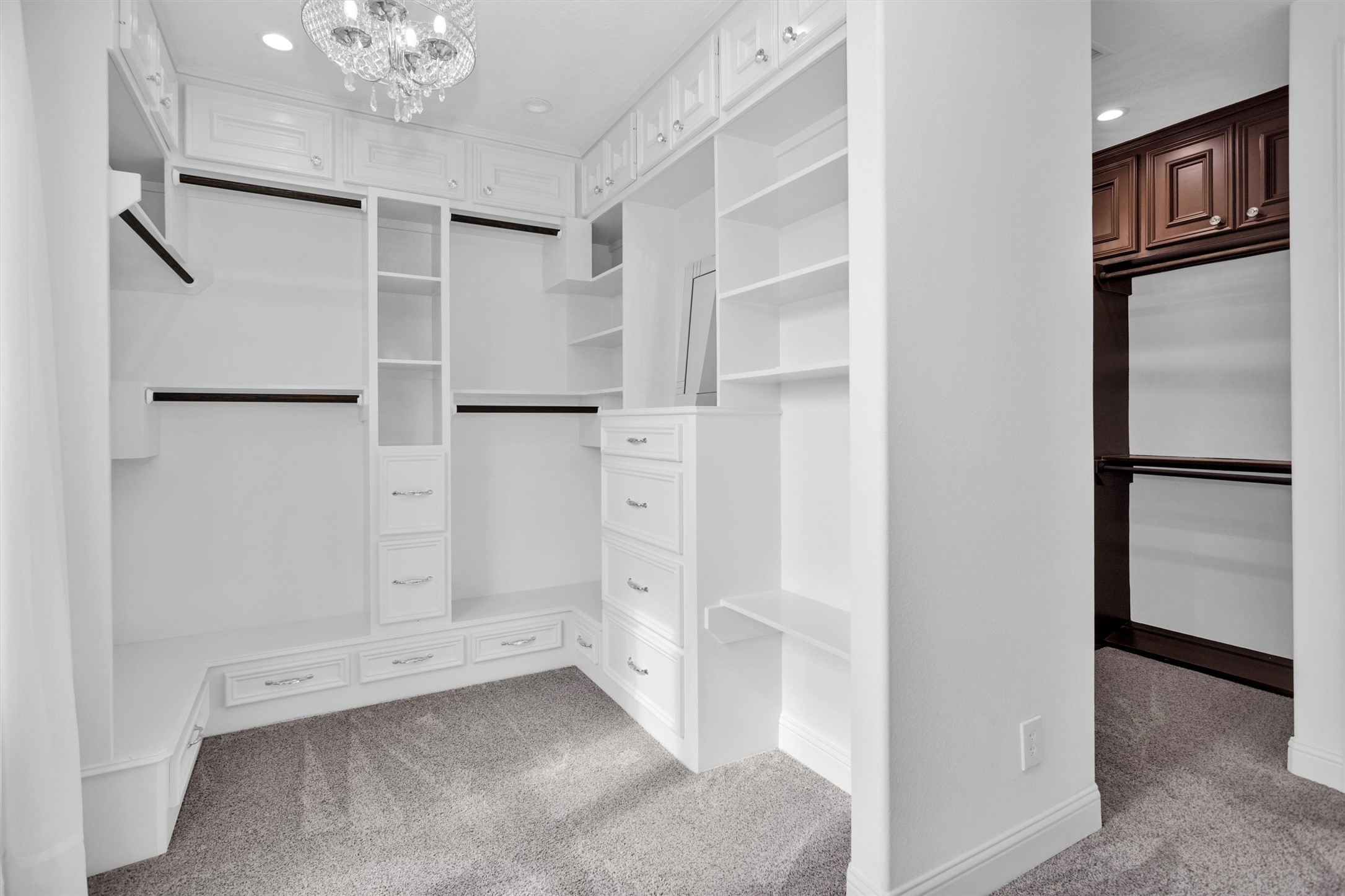 10887 Decatur Street Willis, TX 77318 - Photo 30 of 50 One of two exquisite primary closet spaces offering a light and bright design with full built-ins, dedicated shelving, and a vanity-style counter area—perfect for getting ready.