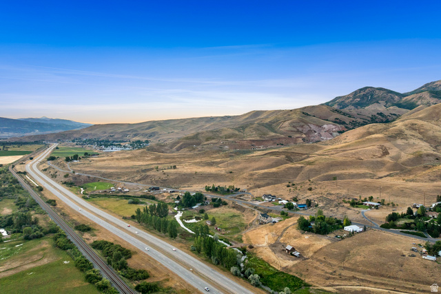 1940 West Old Hwy Road Morgan, UT 84050 - Photo 61 of 73 Rural landscape featuring a highway, railroad tracks, and natural terrain with distant mountainous formations