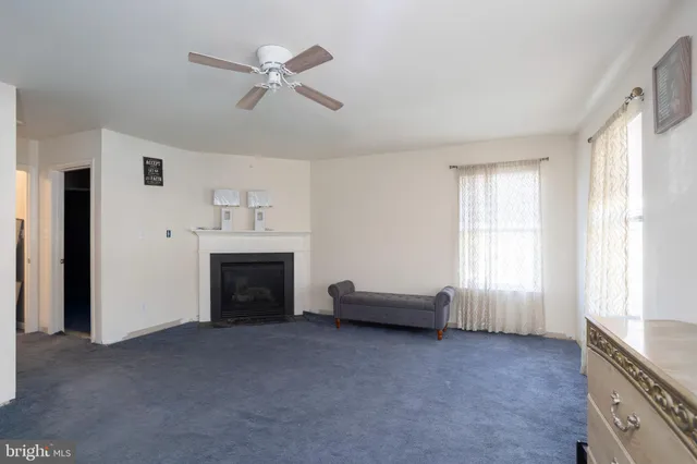 a view of livingroom with furniture fireplace and window