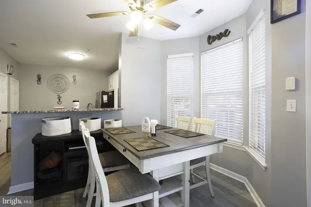a view of a dining room with furniture and wooden floor