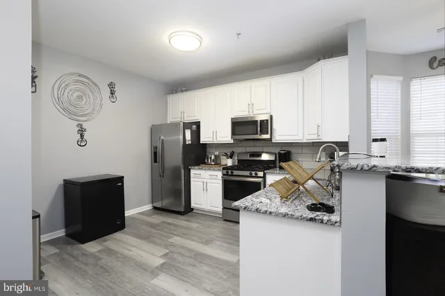 a kitchen with a refrigerator stove and microwave