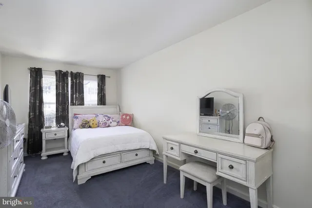 a bedroom with a bed next to a window with outer view