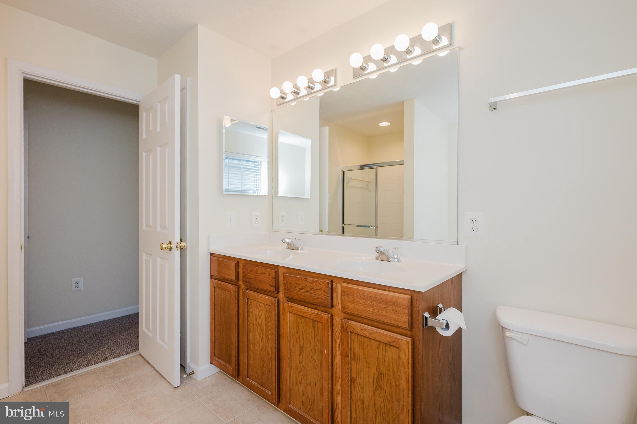 719 MacDill Road Middle River, MD 21220 - Photo 12 of 35 a bathroom with a sink a toilet a mirror and a shower