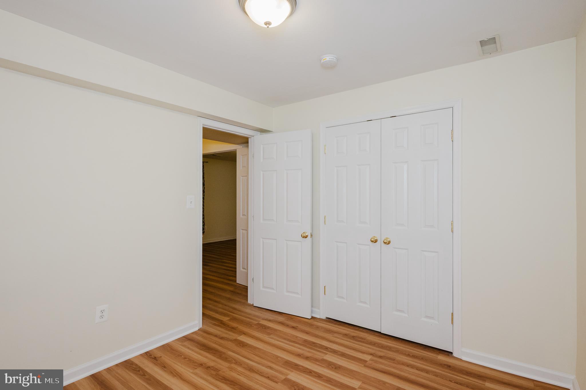 719 MacDill Road Middle River, MD 21220 - Photo 26 of 35 an empty room with wooden floor and closet