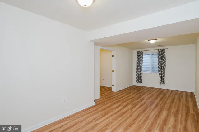 a view of a room with wooden floor and bathroom