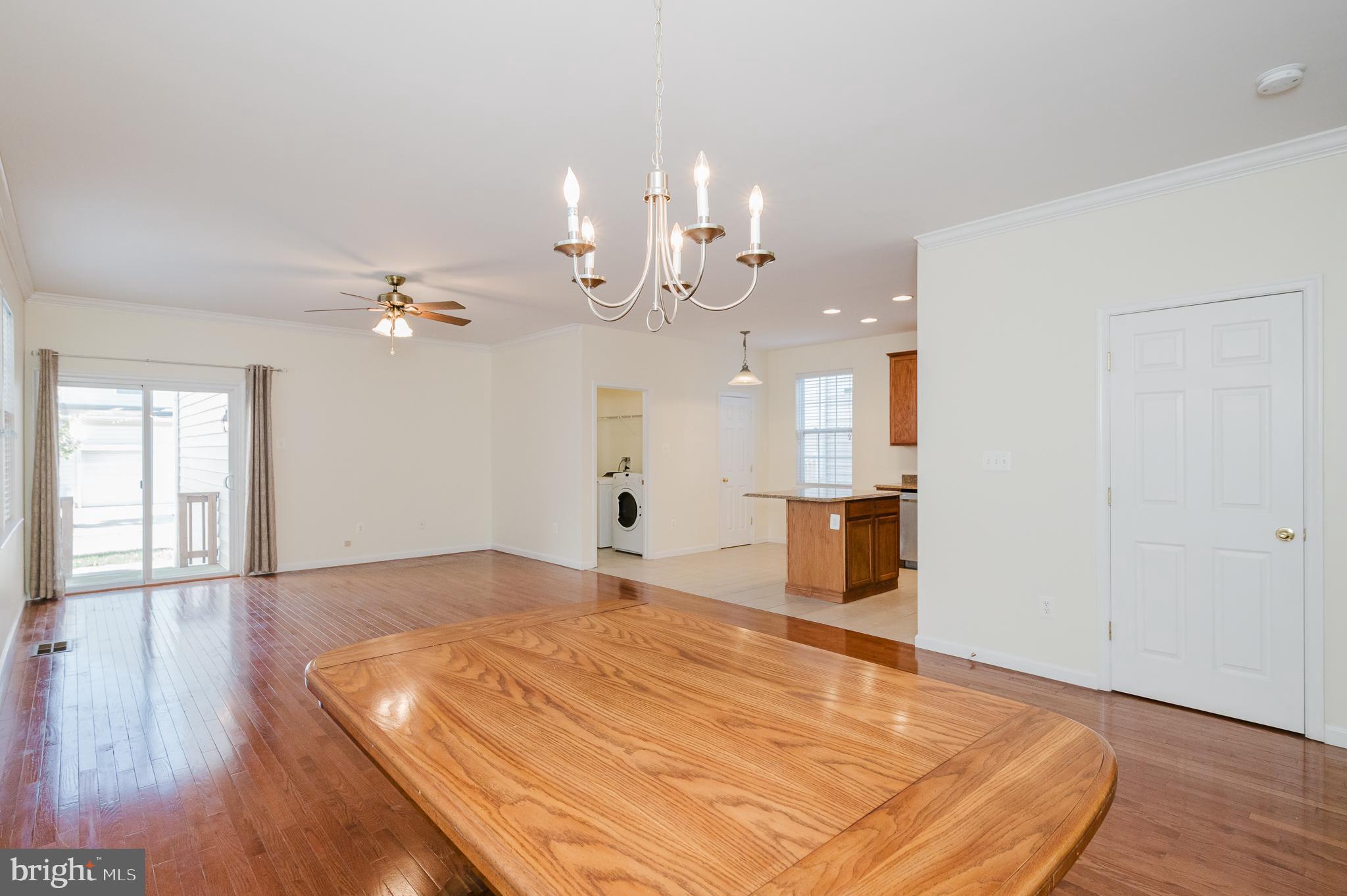 719 MacDill Road Middle River, MD 21220 - Photo 4 of 35 a view of an empty room with wooden floor and a kitchen