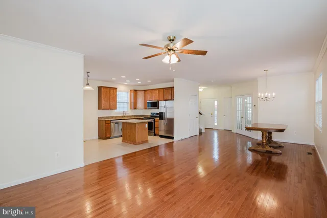 a view of a living room and kitchen with hardwood floor