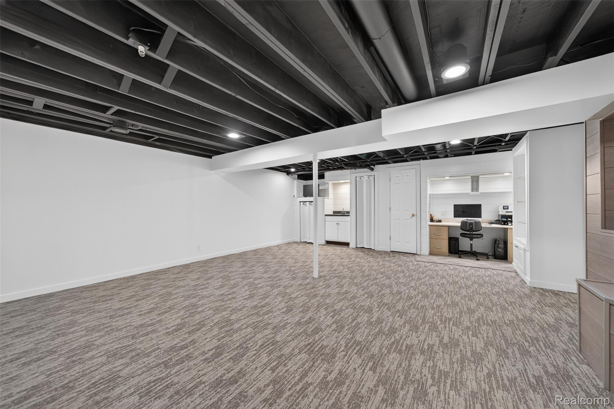 1236 Chaffer Drive Rochester, MI 48306 - Photo 47 of 76 Spacious room featuring patterned carpeting, recessed lighting, white walls, and a painted exposed ceiling