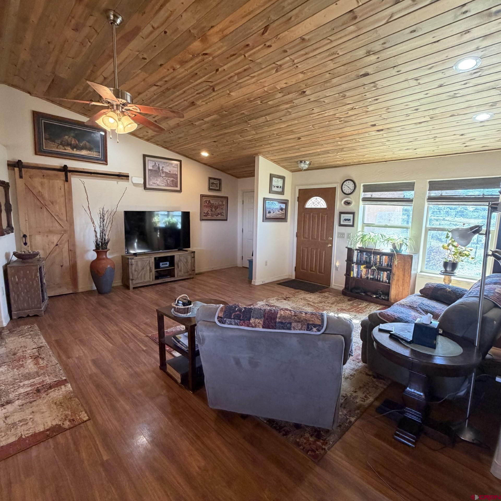 14617 2800th Road Hotchkiss, CO 81419 - Photo 15 of 37 a living room with furniture and a flat screen tv