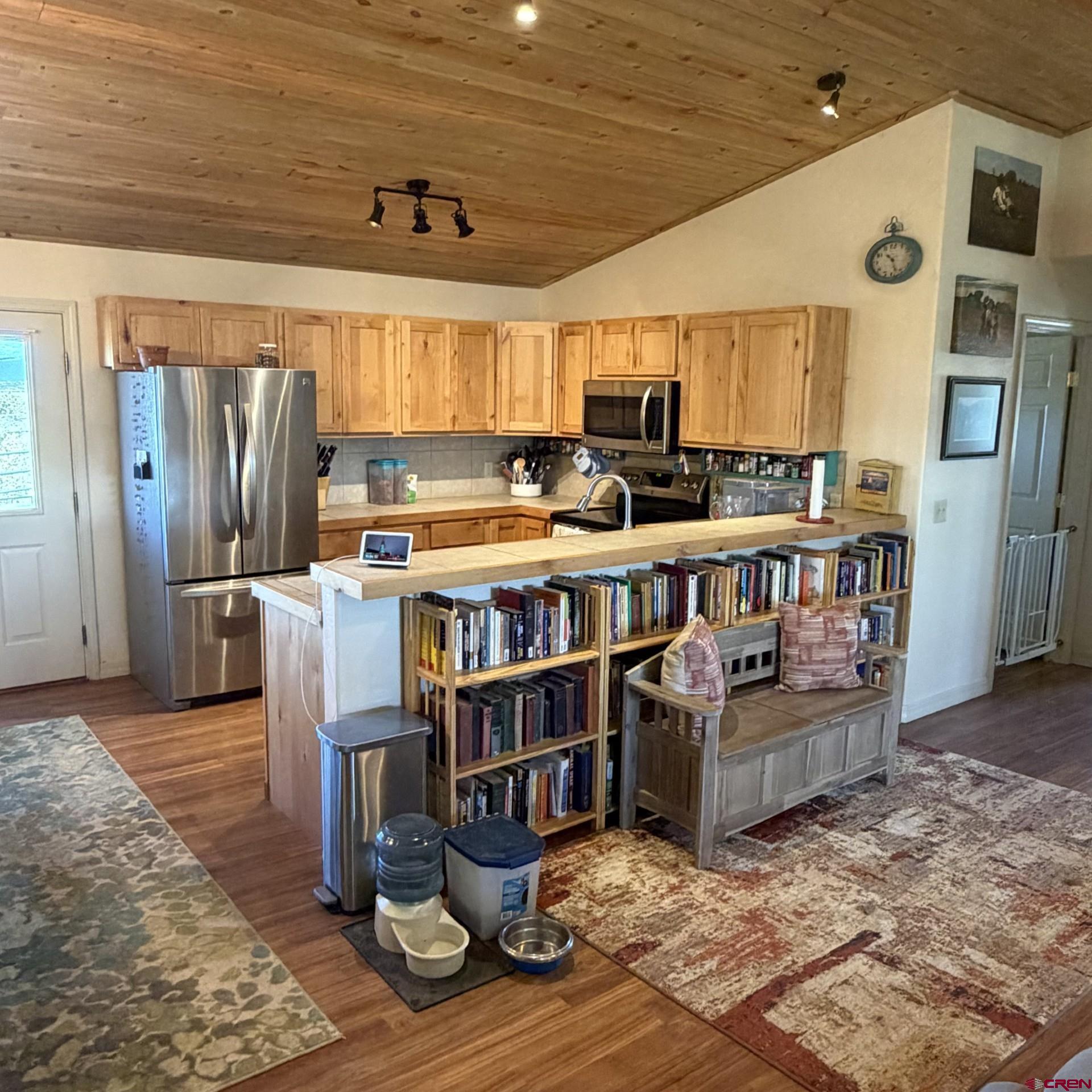 14617 2800th Road Hotchkiss, CO 81419 - Photo 17 of 37 a kitchen with stainless steel appliances granite countertop a stove and a refrigerator